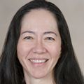 Dawn Nolt, M.D. (OHSU) stands against a beige background.