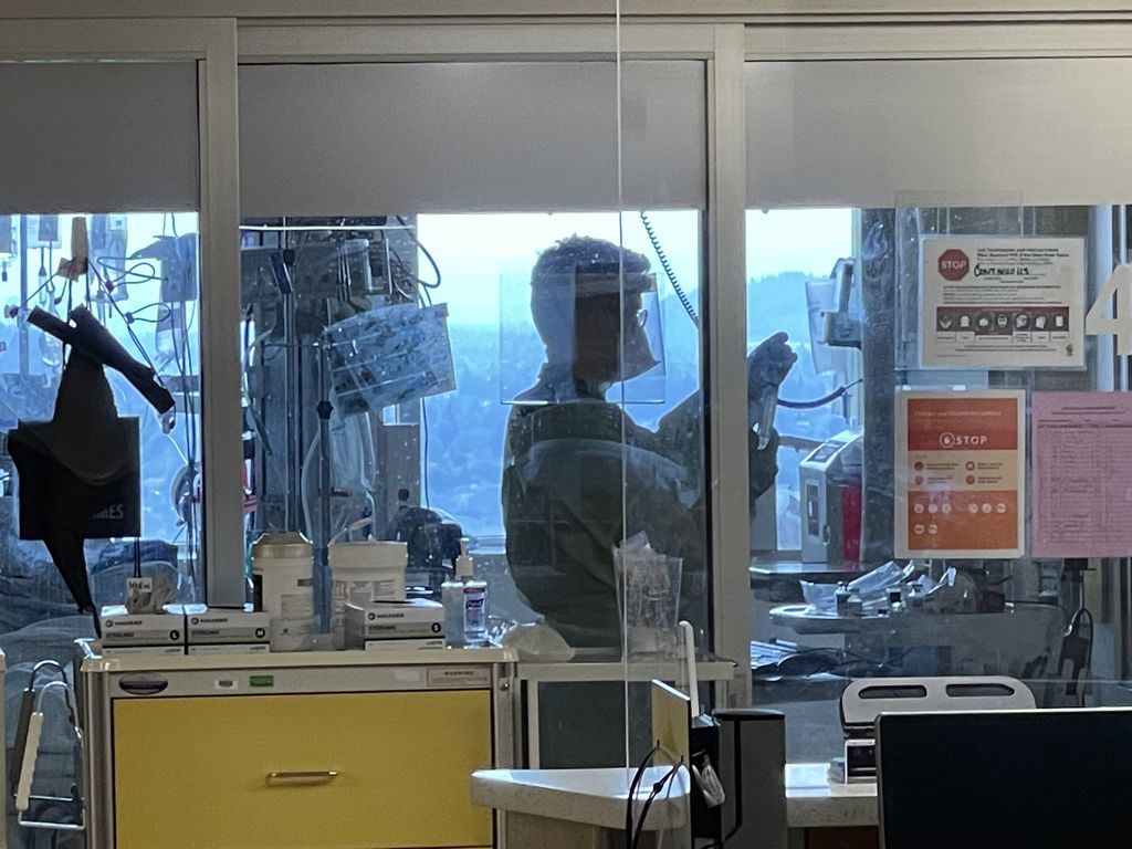 A doctor prepares medication for a patient in OHSU's medical intensive care unit Aug. 19. COVID-19 hospitalizations are on a decline. (OHSU/Erin Hoover Barnett)