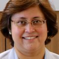 Portrait of Shivaani Kummar M.D. FACP, a bespectacled woman in a white blazer.