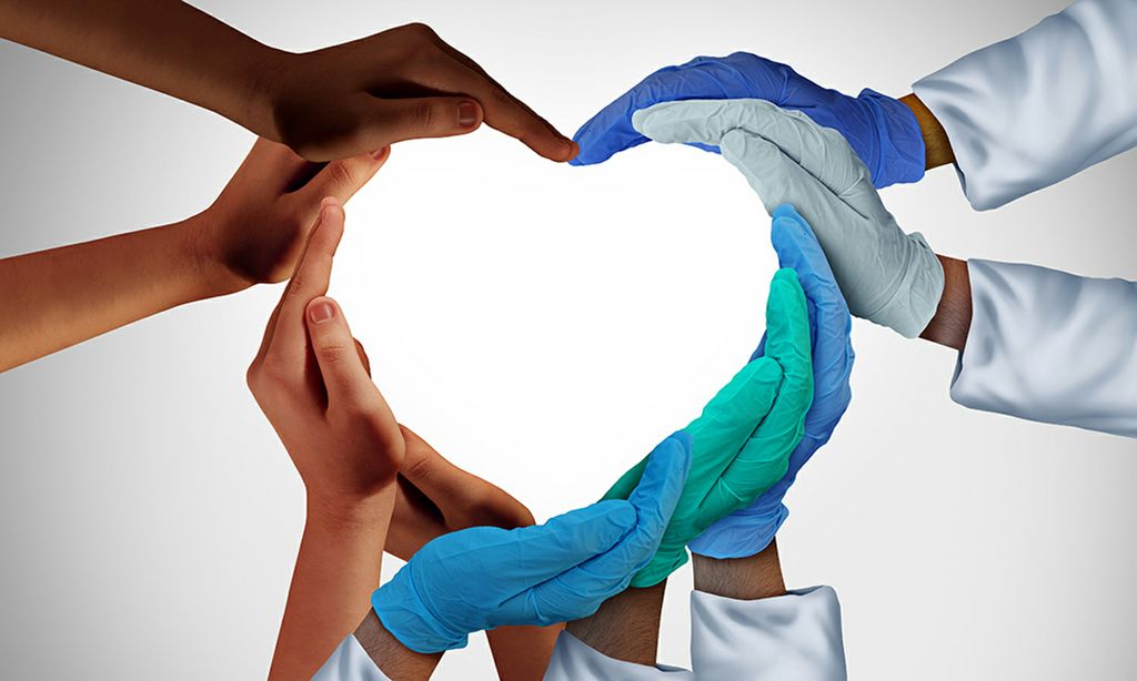 An image of multiple people's hands together forming a large heart shape.