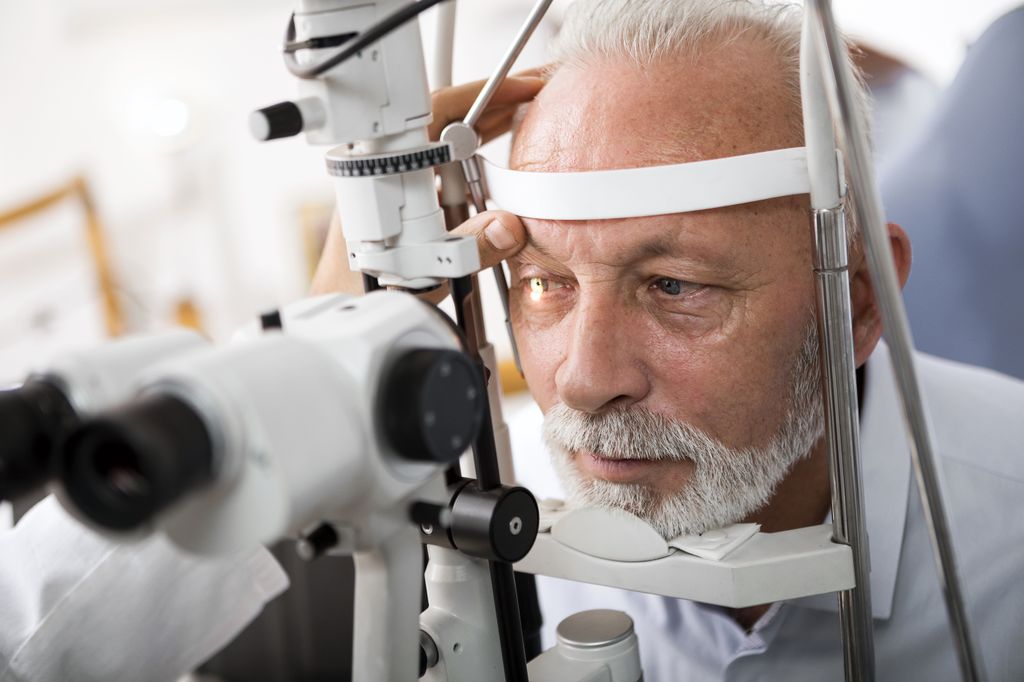A doctor checks a patient's eyes.