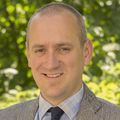 A picture of Benjamin Sivyer, Ph.D. (OHSU). A man wearing a suit, smiling.