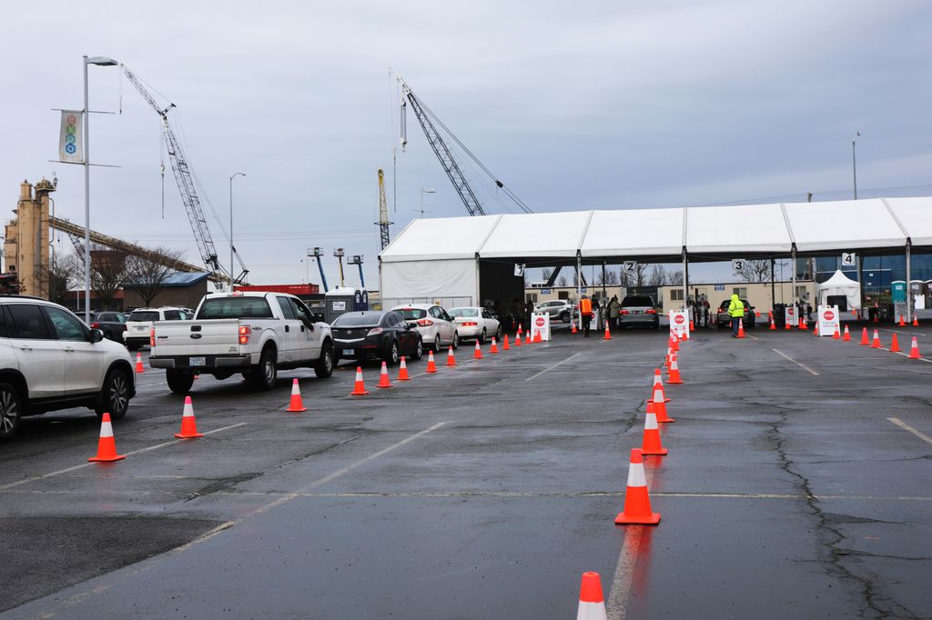Portland Expo Center community COVID testing site with several cars in line waiting for testing on an overcast day.