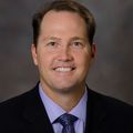 Jason C. Hedges, M.D., Ph.D. (OHSU) A man with brown hair smiling.
