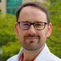 George Burwood, Ph.D., stands out on the OHSU lawn with the OHSU Hospital in background.  (OHSU)