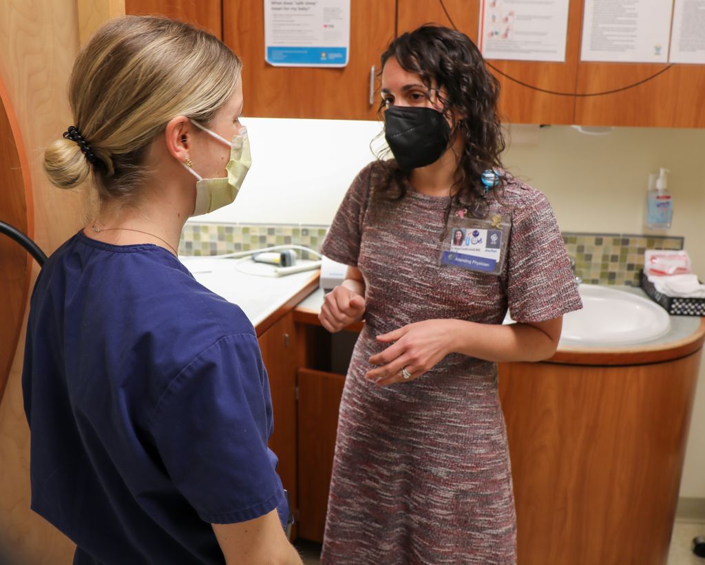 Alyssa Colwill, M.D., right, speaks with a medical resident training at the OHSU Center for Women’s Health. OHSU’s reproductive health curriculum includes abortion care. Because of abortion bans in certain states, OB/GYN residents aren’t able to train in this basic piece of their education in their home states. (OHSU/Christine Torres Hicks)