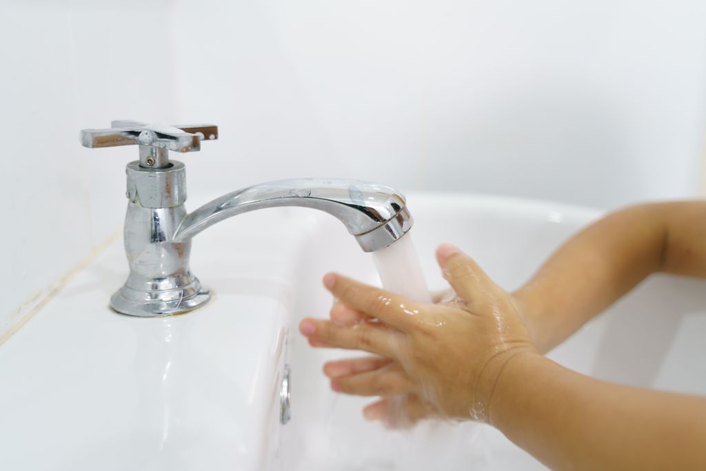 Photo of a kid washing hands in a bathroom sink. To prevent the spread of respiratory viruses, keep sick kids home from school and events; avoid contact with anyone who is sick; wash hands frequently; and, stay up to date on all vaccines. (Getty Images)