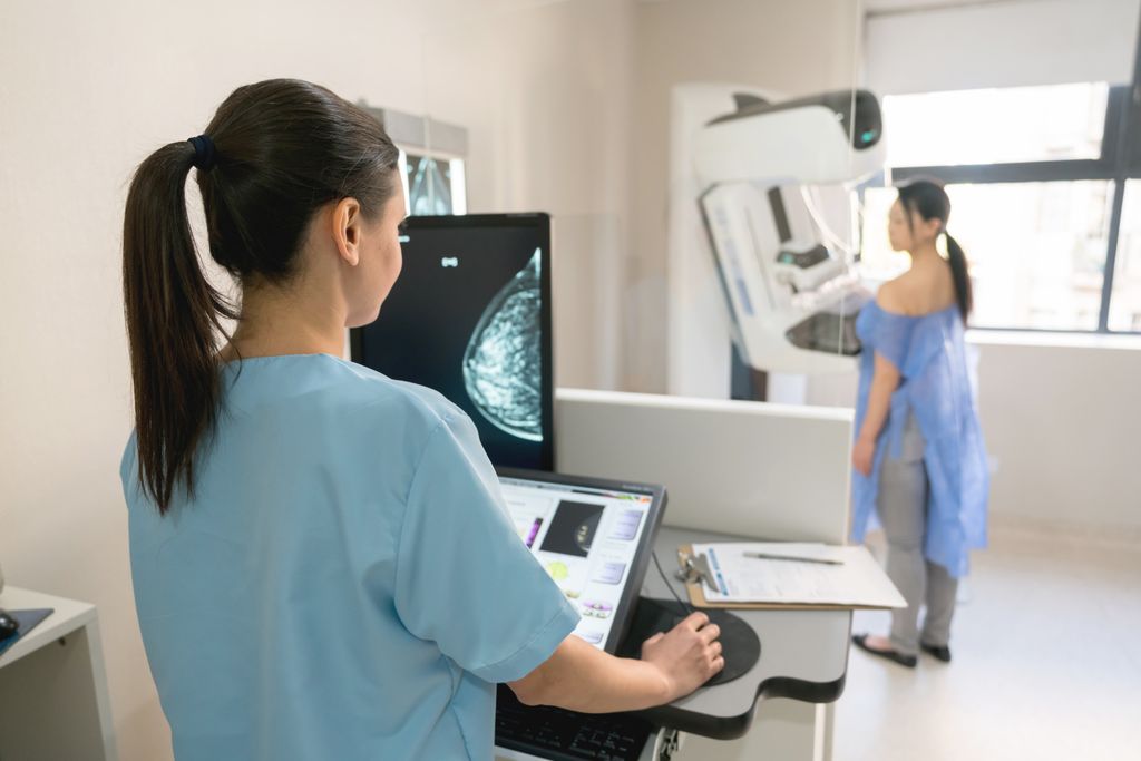 A nurse takes a mammogram exam of a female patient at the hospital.