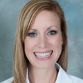 Adrienne Hughes, M.D. a person with long blond hair, smiling.