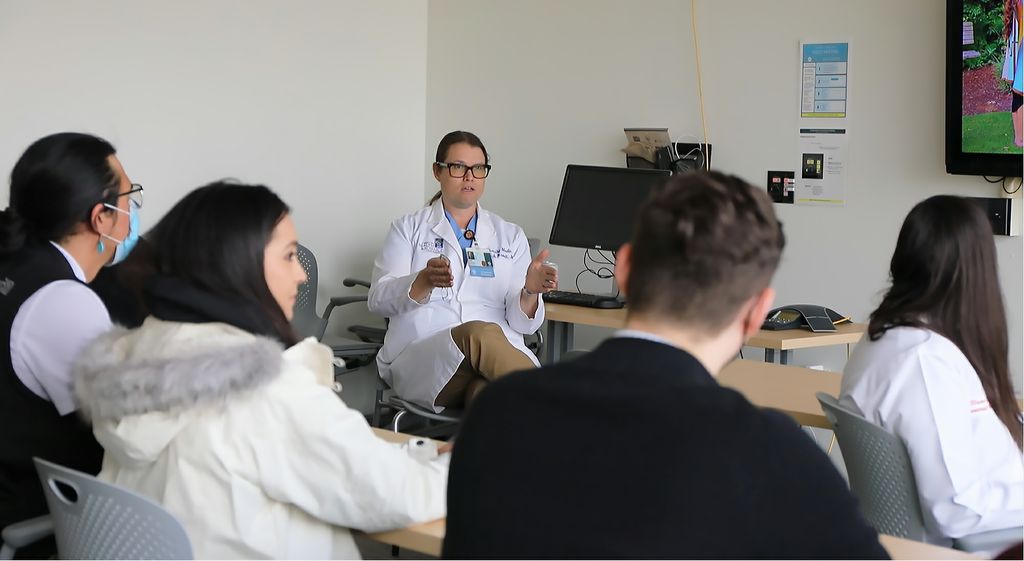 OHSU Northwest Native American Center of Excellence director Erik Brodt, M.D., center, speaks with medical students who previously completed the center’s Wy’est Post-Baccalaureate Pathway on April 12 2022, in Portland, Oregon. Wy’east helps talented Native students overcome obstacles that can otherwise prevent them from studying medicine. (OHSU/Christine Torres Hicks)