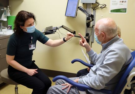 Marian Dale, M.D., M.C.R., with patient