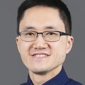Smiling Asian man wearing glasses.