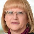 Gina Seufert, B.S.N., R.N. (Adventist Health Tillamook) stands near a window.