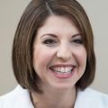 Adult caucasian female with chin-length hair smiles