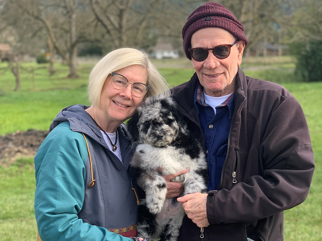 Susan and Jerry Widawski hold thier new puppy in a park.