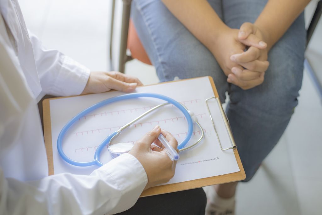 A doctor talking with a woman .
