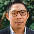 Brian Chan, M.D., M.P.H., stands outside of OHSU Hospital on a sunny summer day.