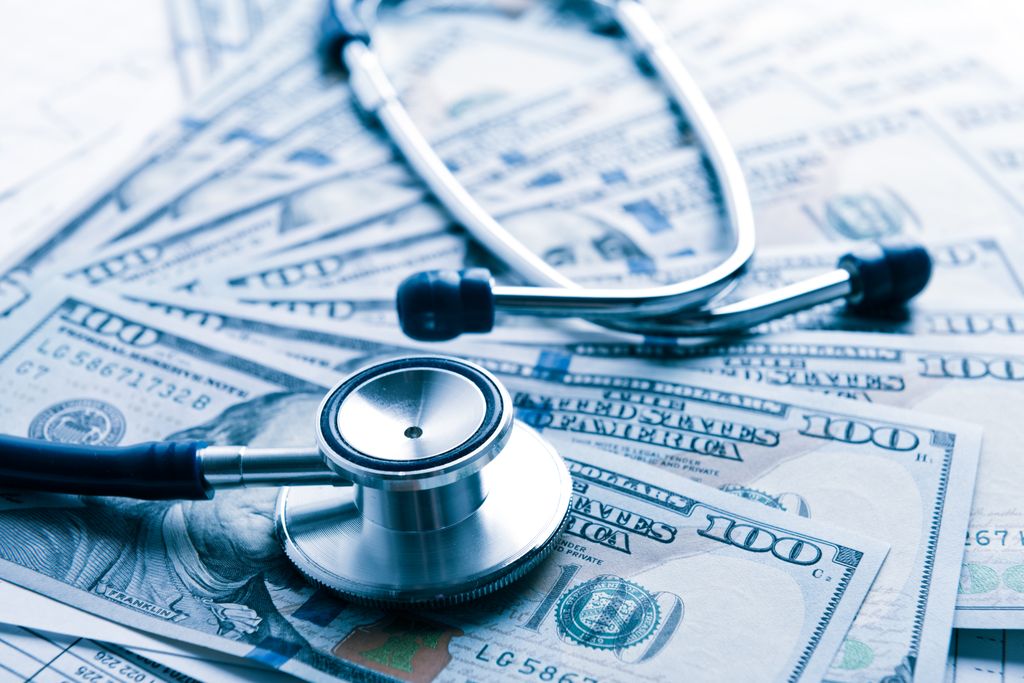 A stethoscope on top of paper money.