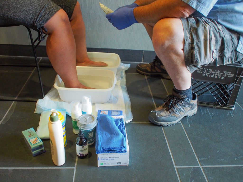 Street nursing program nurse washes the feet of a client.