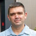 Kyle Ellrott, Ph.D. (OHSU) stands outside the Knight Cancer Institute building at OHSU.