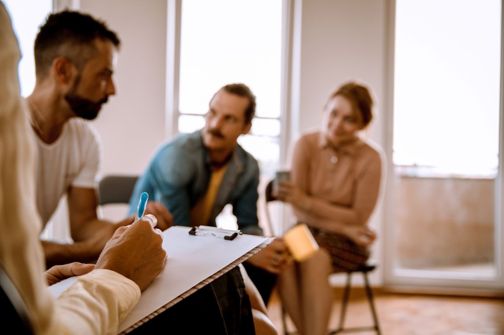 People talking in an office with a counselor.