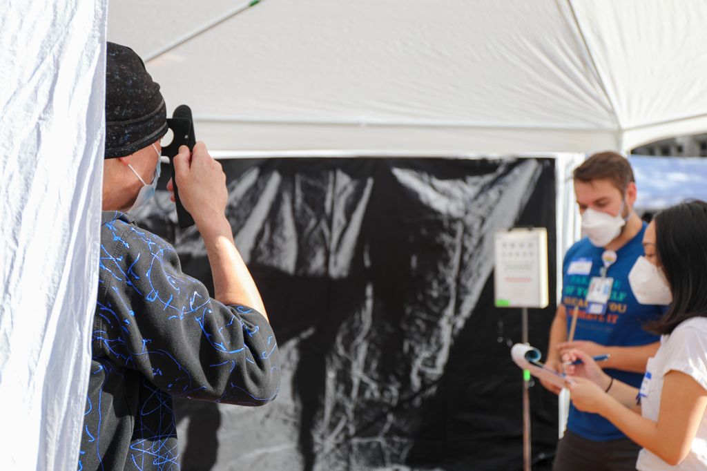 A man gets his eyes checked at the OHSU Casey Eye clinic booth at the Health Equity Fair.