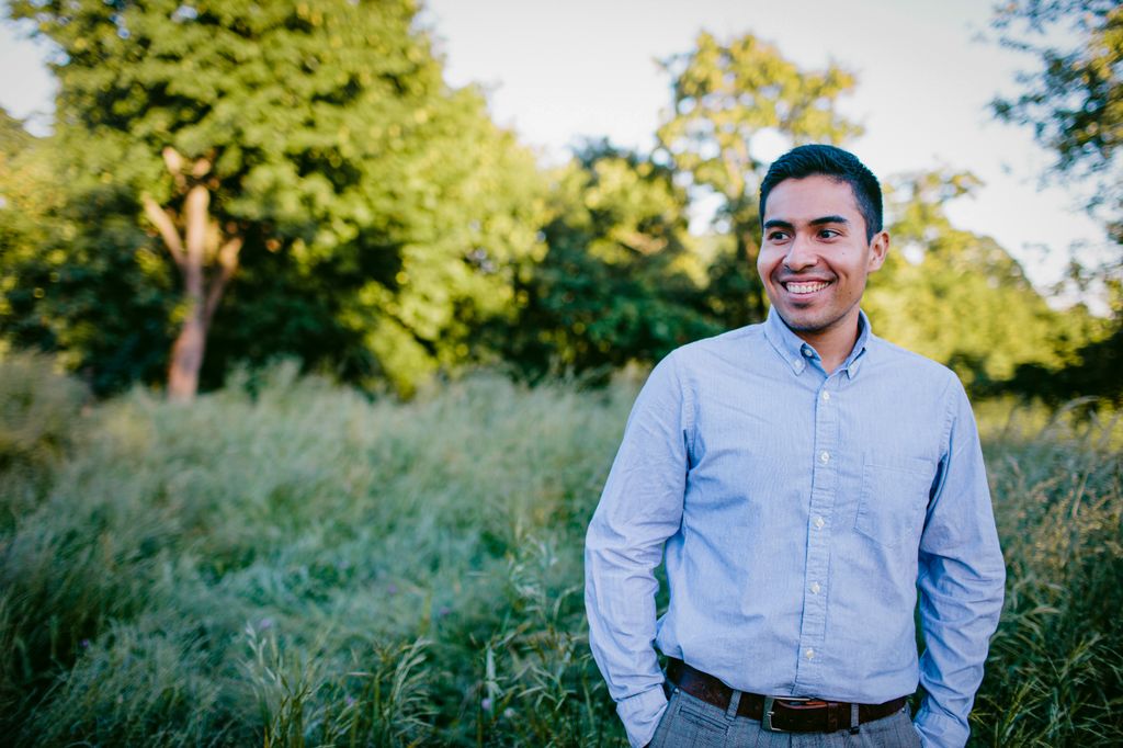 Miguel Marino, Ph.D., stands near greenery.