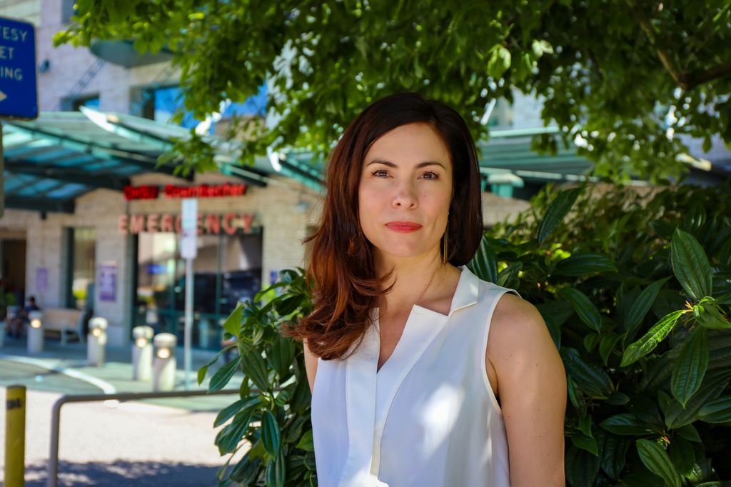 Kathleen Carlson, Ph.D., director of the new center and an associate professor in the OHSU-Portland State University School of Public Health, stands outside the OHSU Hospital emergency department on Marquam Hill in Portland on June 23, 2022. (OHSU/Christine Torres Hicks)