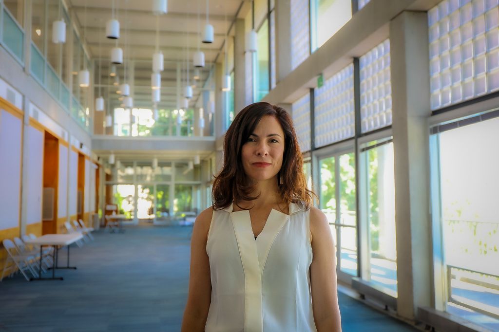 Kathleen Carlson stands inside an OHSU BICC conference room.