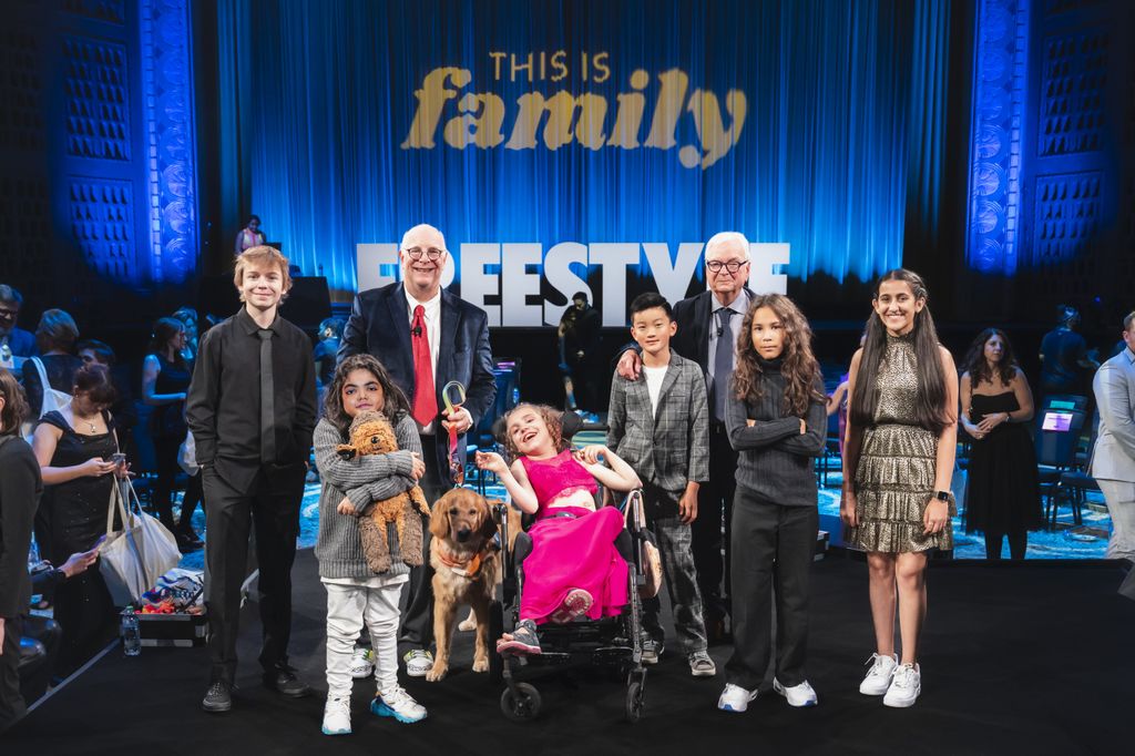 Doernbecher Freeestyle XVIII designers, from left, Emerson Harrell, Dario Villaseñor Valdivia, Kylee Young,&nbsp;Jaren Heacock,&nbsp;Coley Miller, and&nbsp;Riddhi Mahajan pose with&nbsp;Dana BranerDana Braner, M.D., FAAP, FCCM, Credit Unions for Kids chair and professor of pediatrics (critical care) in the OHSU School of Medicine, and physician-in-chief for OHSU Doernbecher Children’s Hospital, back left, OHSU Child Life therapy dog Davis, and&nbsp;Nike&nbsp;Global creative director&nbsp;Michael Doherty, back right. (OHSU/Jordan Sleeth)