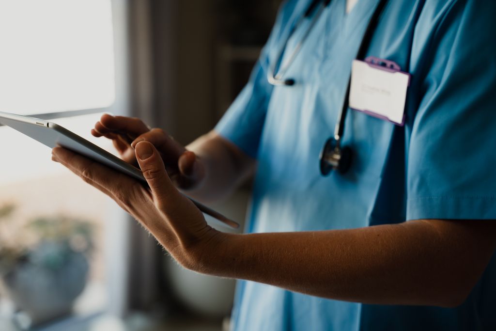 A physician assistant in a medical office looks over a chart. An OHSU-led study shows private equity relies more on advanced practice providers for medical care. (Getty Images)
