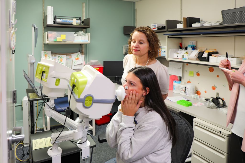 Cindy McEvoy studies research participant, Sadie Schweitzer, 15, at the McEvoy lab at OHSU. Alongside a national cohort of researchers, a team at OHSU is investigating the effect of environmental factors on a child’s long-term respiratory health. (OHSU/Christine Torres Hicks)