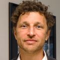 Marcel Curlin, M.D., has short light brown hair, smiling, while standing in the hallway of Mackenzie Hall at OHSU. (OHSU)