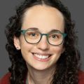 BreAnna Dupuis, LCSW, has long curly hair and wears glasses. and is smiling in this photo of just Dupuis' head.  (Courtesy)