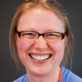 Ladawna Gievers, M.D. (OHSU) has blonde hair in a ponytail and black-framed glasses and smiling in this photo of just her head.
