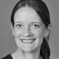 Lauren Mutrie, M.D. (OHSU) head photo. Mutrie has hair in a low ponytail and is smiling. Photo is black and white. Lauren Mutrie, M.D. (OHSU)