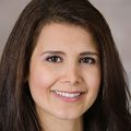 Delaram Safarpour, M.D. (OHSU) has long brown hair, smiling.