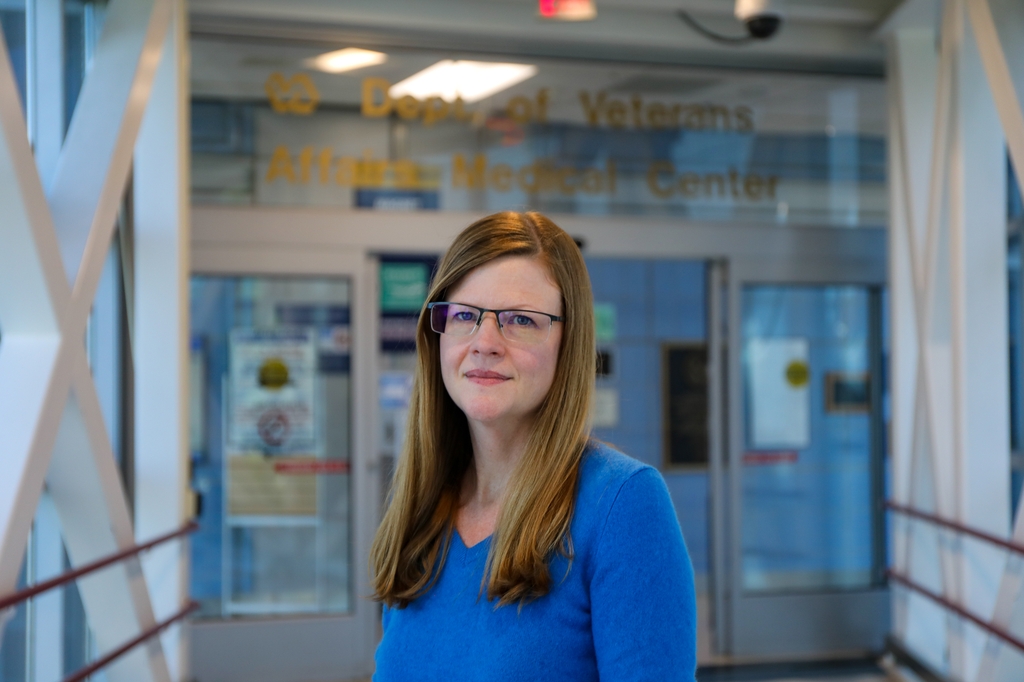 Lauren Denneson, Ph.D., M.S., professor of psychiatry in the OHSU School of Medicine and associate director of the Center to Improve Veteran Involvement in Care at the VA Portland Health Care System, stands outside the entrance to the VA Hospital from the OHSU skybridge. According to Denneson's research,&nbsp;women veterans are at higher risk for repeat suicide attempts. (OHSU/Christine Torres Hicks)