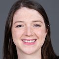 Molly Kornfield, M.D., tiene cabello largo, castaño y liso y sonríe sobre un fondo gris.