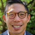 Brian Chan, M.D., M.P.H., tiene cabello corto y oscuro, anteojos y viste un traje azul cerca del Hospital OHSU.