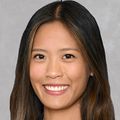 Christine Nguyen Dawson, M.D., has wavy brown hair, a black dress jacket and is smiling.