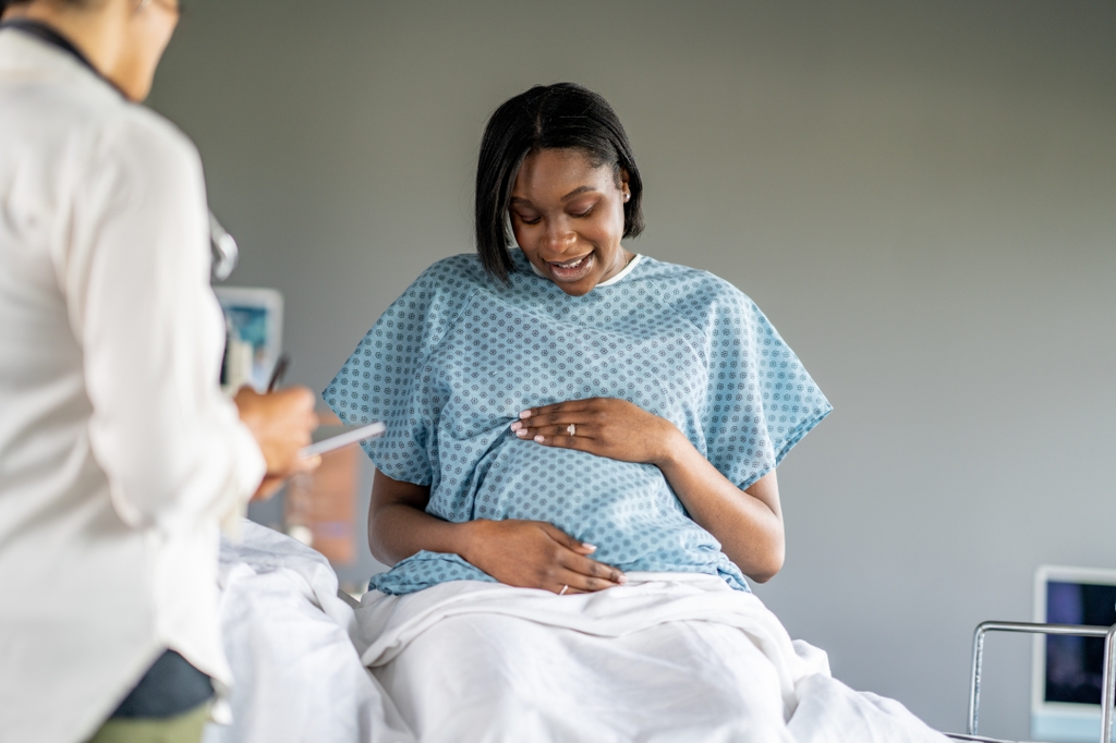 A pregnant patient prepares for a prenatal exam at a Hospital.