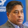 Atif Zaman, M.D., has short dark hair, a gray suit and is speaking at the roundtable.