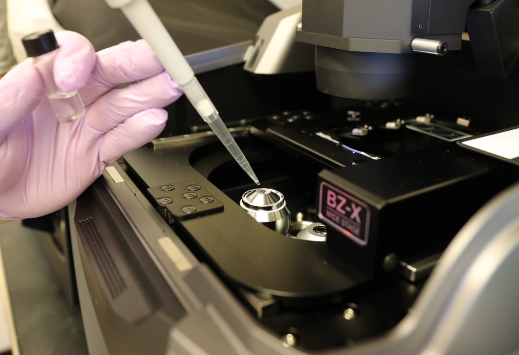 Researcher prepares imaging equipment in OHSU oral microbiome laboratory