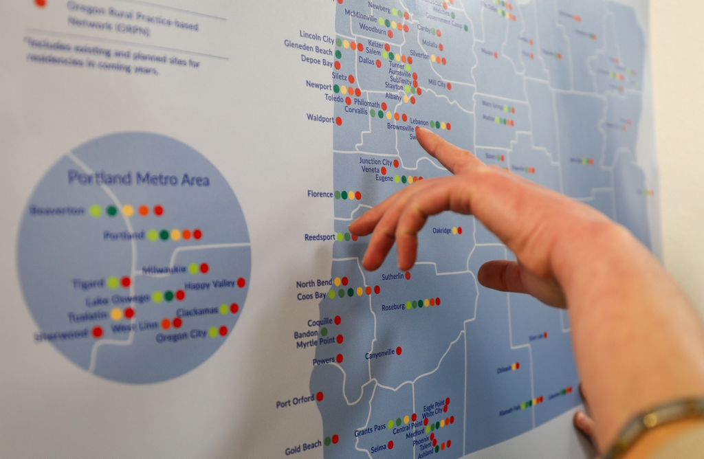 The Oregon Health & Science University and University of Washington rural practice networks have secured renewed funding to support their partnerships with rural communities across Oregon and the Northwest, ensuring groundbreaking research reaches people where they live. (OHSU/Christine Torres Hicks) A hand points to a location on an OHSU ORPRN map, close up view, in an OHSU office in Portland, Oregon.