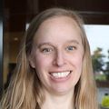 Melinda Davis, Ph.D., MCR (OHSU) Melinda has long blonde hair, a gray suit jacket and a floral top, smiling outside an OHSU building in Portland, Oregon.