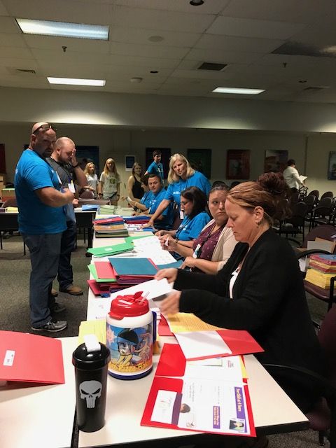 Oconee Nuclear Station employees stuffing backpacks for the School District of Oconee County