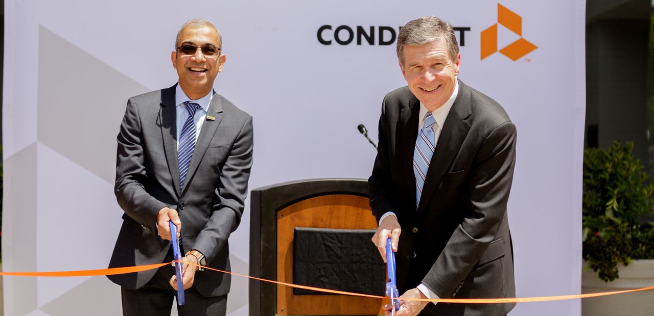 Conduent Incorporated’s CEO Ashok Vemuri and North Carolina Governor Roy Cooper celebrate the opening of Conduent’s technology and innovation hub in Morrisville, N.C.