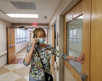 Sheree Jones does a phone visit with a patient. 