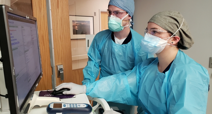 Zach Matthews RN and Jessica Walls RN at work in the ICU at Novant Health Forsyth Medical Center